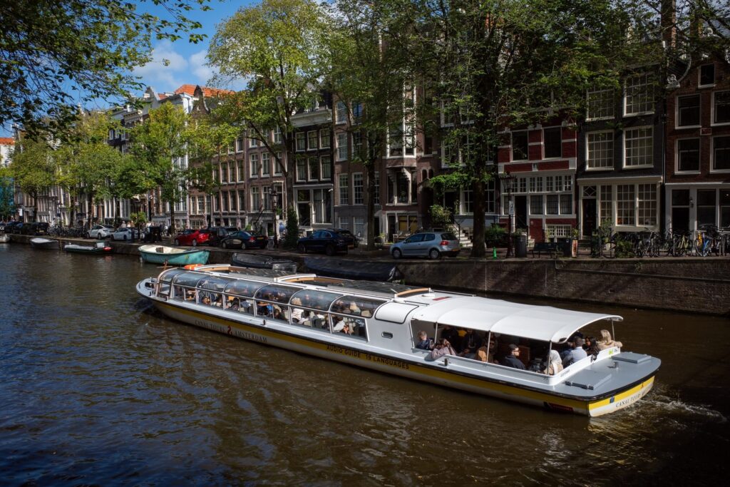 Glass-topped canal cruise boat on an Amsterdam canal