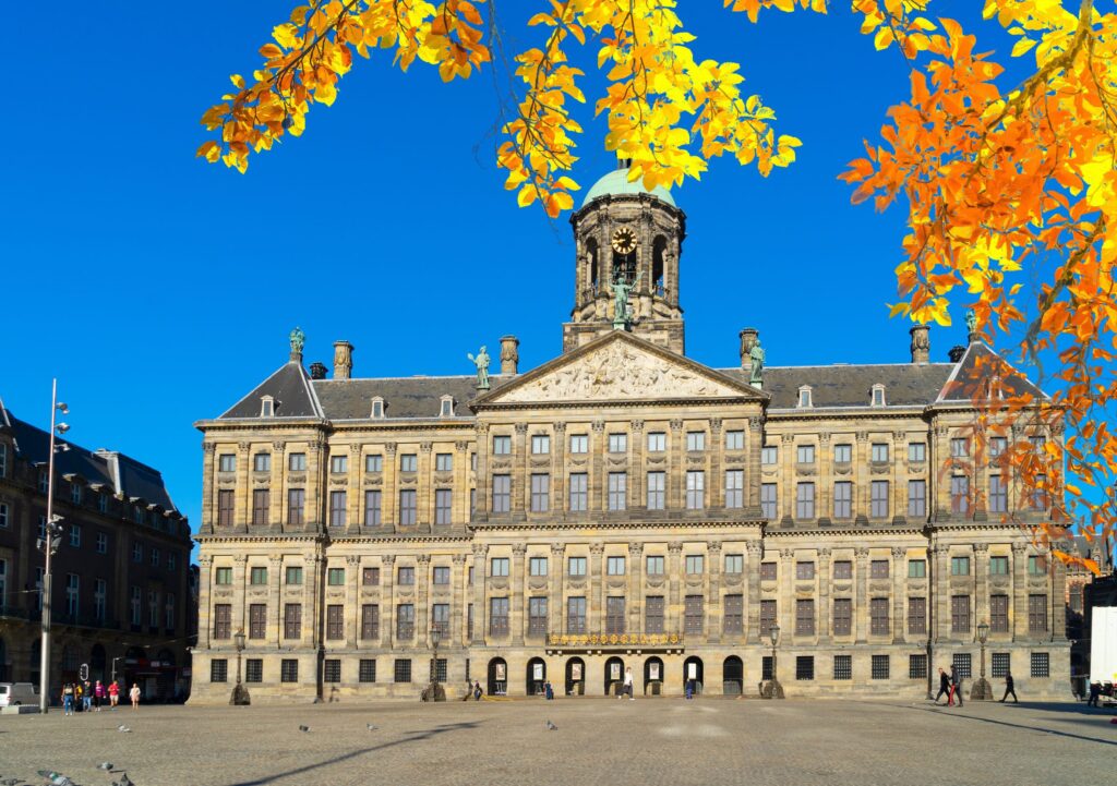 Royal Palace on Dam Square framed by autumn leaves
