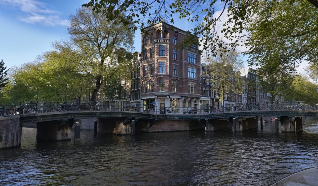 Amsterdam canal corner with a bridge and historic canal houses