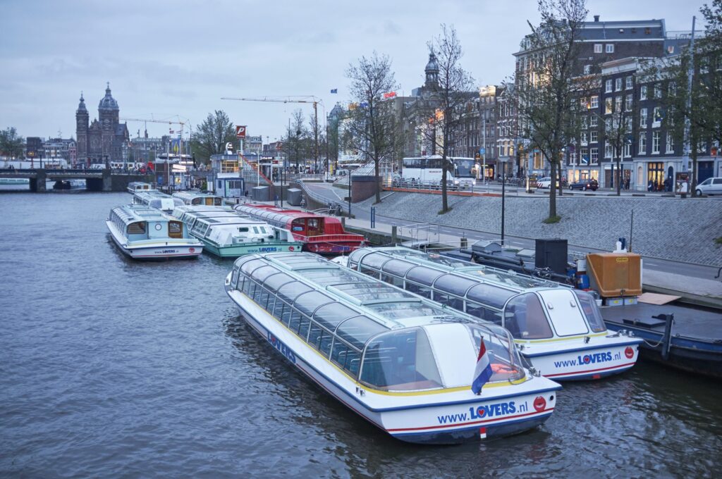 Ferries and canal boats on the IJ near Amsterdam Central Station