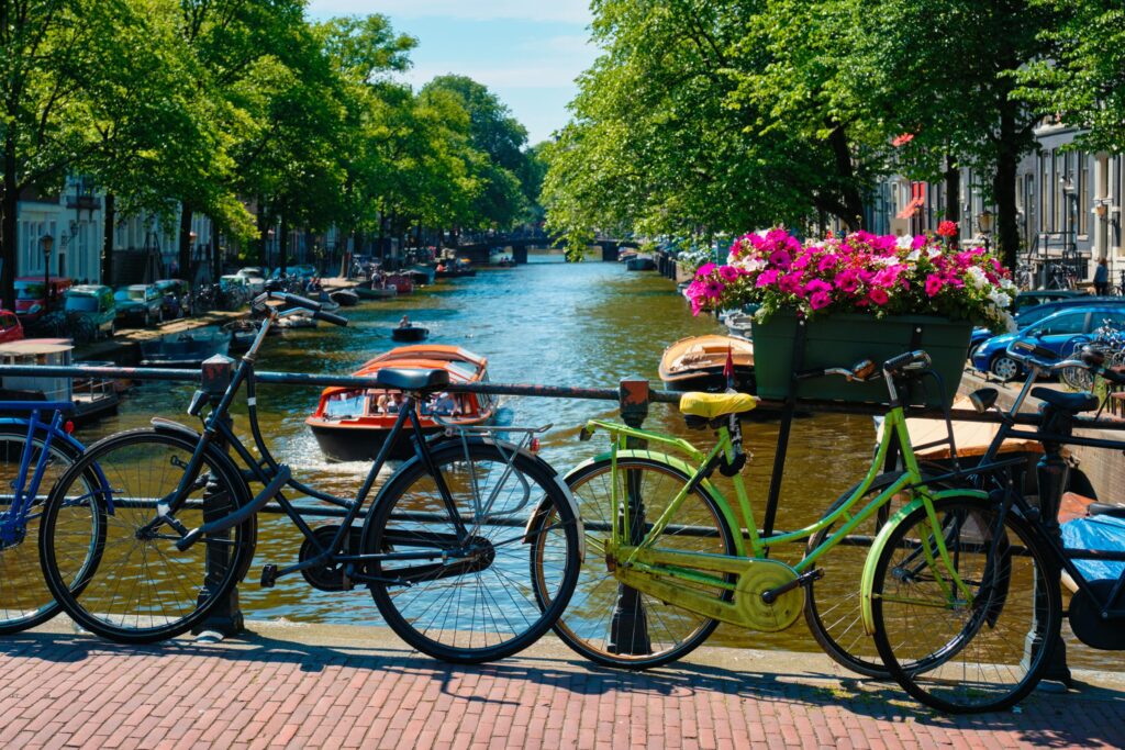 Bicycles and flowers on a bridge over an Amsterdam canal